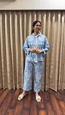 Powder blue linen blend button down shirt white thread embroidery featuring intricate floral and paisley patterns. Same matching flare bottom