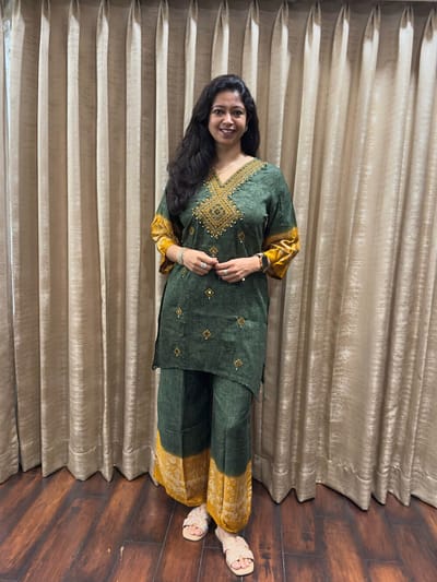 Deep forest green with mustard yellow  Linen blend cotton thread & mirror work adding festive sparkle  Wide legged straight pant of same art work